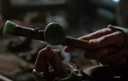 Jack Rackham holding an opium pipe.