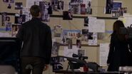 Tom right behind Liz as she examines the walls of evidence.