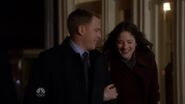 Ressler and Audrey walk arm in arm smiling as they exit the restaurant.