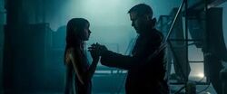 Joi touches K's hand to have him feel her presence
