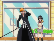 Kon clings to Rukia's shoulder as she tells Ichigo to get changed.