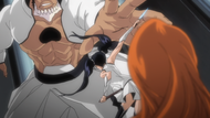 Loly slices Yammy's hand, protecting Orihime.