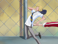 Hiyori kicks Shinji in the rear end.