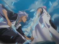 Gin has his arm bound and frozen by Hitsugaya.