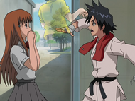 Tatsuki shoos a Plus away as Orihime watches in confusion.