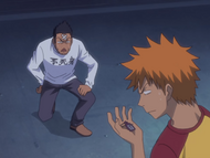 Ichigo is given a protective charm by Isshin Kurosaki.