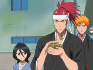 Kon watches as Renji is given onigiri to eat later.