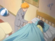 Ichigo tucks Karin into bed.