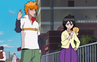 Kon rests on Rukia's shoulder.