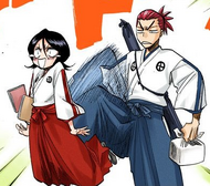 Renji kicks Rukia in the backside for standing around.