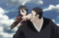 Rukia hits the Shinigami in the face.