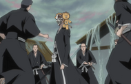 Several Shinigami surround Ichigo and Kon.