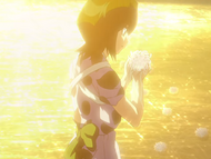 Rukia finds a flower in the river.