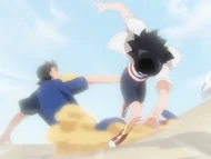 One of the students slides into Karin's legs to topple her.