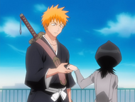 Rukia gives Ichigo Kon's pill.