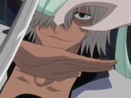Di Roy blocks Rukia's Zanpakutō with his hand.