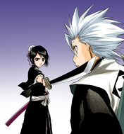 Hitsugaya is stunned to find Hinamori pointing her Zanpakutō at him.