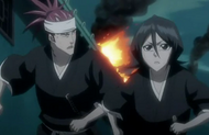 Renji and Rukia run in the chaos.