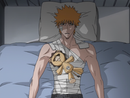 Kon sleeps on a distraught Ichigo's chest.