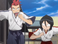 Renji and Rukia run through the Rukongai toward the Shin'ō Academy.