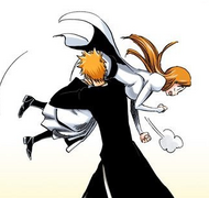 Ichigo hoists Orihime over his shoulder.