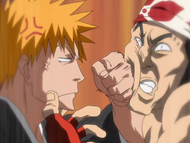 Ichigo punches Ganju in the face.