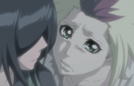 Homura looks up at Rukia with tears in her eyes.