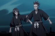 Renji grabs Rukia's sleeve.