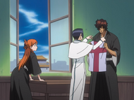 Orihime watches Uryū give Sado a new shirt.