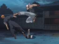 Ganju kicks Ichigo in the head.