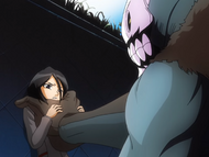 Shrieker pins Rukia to a wall.