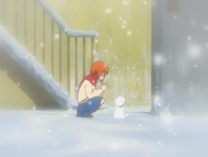 A young Orihime makes a snowman shaped like a rabbit.