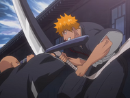 Ikkaku blocks Ichigo's attack with his scabbard.