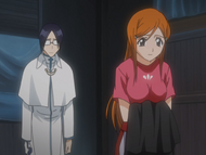 Orihime takes the clothes of the unconscious Shinigami.