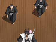 Kenpachi walks through a hallway with his subordinates.