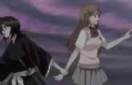 Rukia pulls Orihime back.