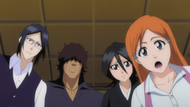 Sado, Orihime, Rukia and Uryū stand over Ichigo as he awakens.