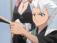 Hitsugaya takes the book from Ran'Tao.