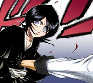 Grimmjow stabs his hand into Rukia's abdomen.