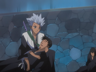 Hitsugaya checks on the injure Shinigami.