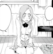 Orihime sits embarrassed in Ichigo's bedroom.