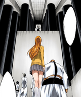 Yammy brings Orihime to Aizen's throne room.