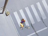 Orihime lies in an intersection after being hit by a car.