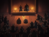 Koga and Ichinose address a town hall.