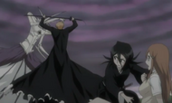 Rukia protects Orihime as Ichigo fights Muramasa.