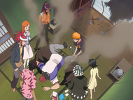 Rukia and her friends stare in shock as Ganju crashes into the Urahara Shop.