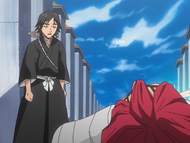 Rikichi stands over Renji as Hanatarō heals him.