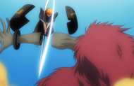 Ichigo Kurosaki cuts off a Hollow's forearm.