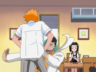 Isshin sews the protective charm onto Ichigo's shirt.