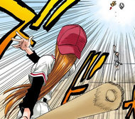 Orihime smacks a baseball bat into Kon, who is sent flying.